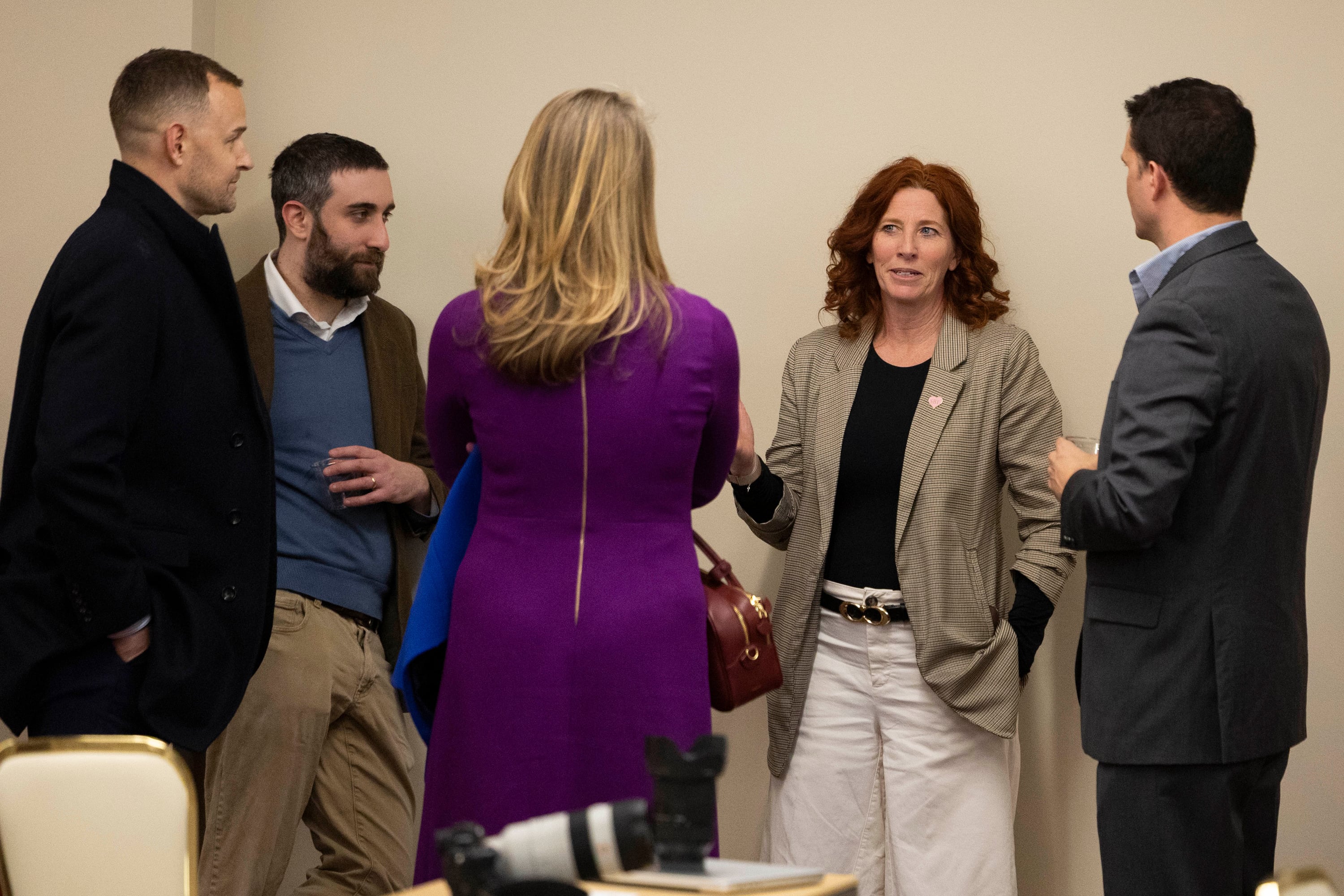 Charles Fain Lehman, Manhattan Institute senior fellow, second left, and Erin Ryan, executive director at the Sherry Black Foundation, second right, speak with attendees before the Utah Crime Summit keynote address at the Thomas S. Monson Center in Salt Lake City on Tuesday.