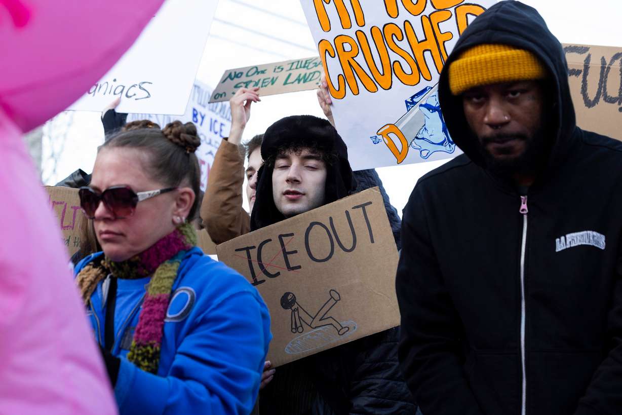 Anti-ICE protesters gather outside the U.S. Citizenship and Immigration Services building in Salt Lake City on Friday.