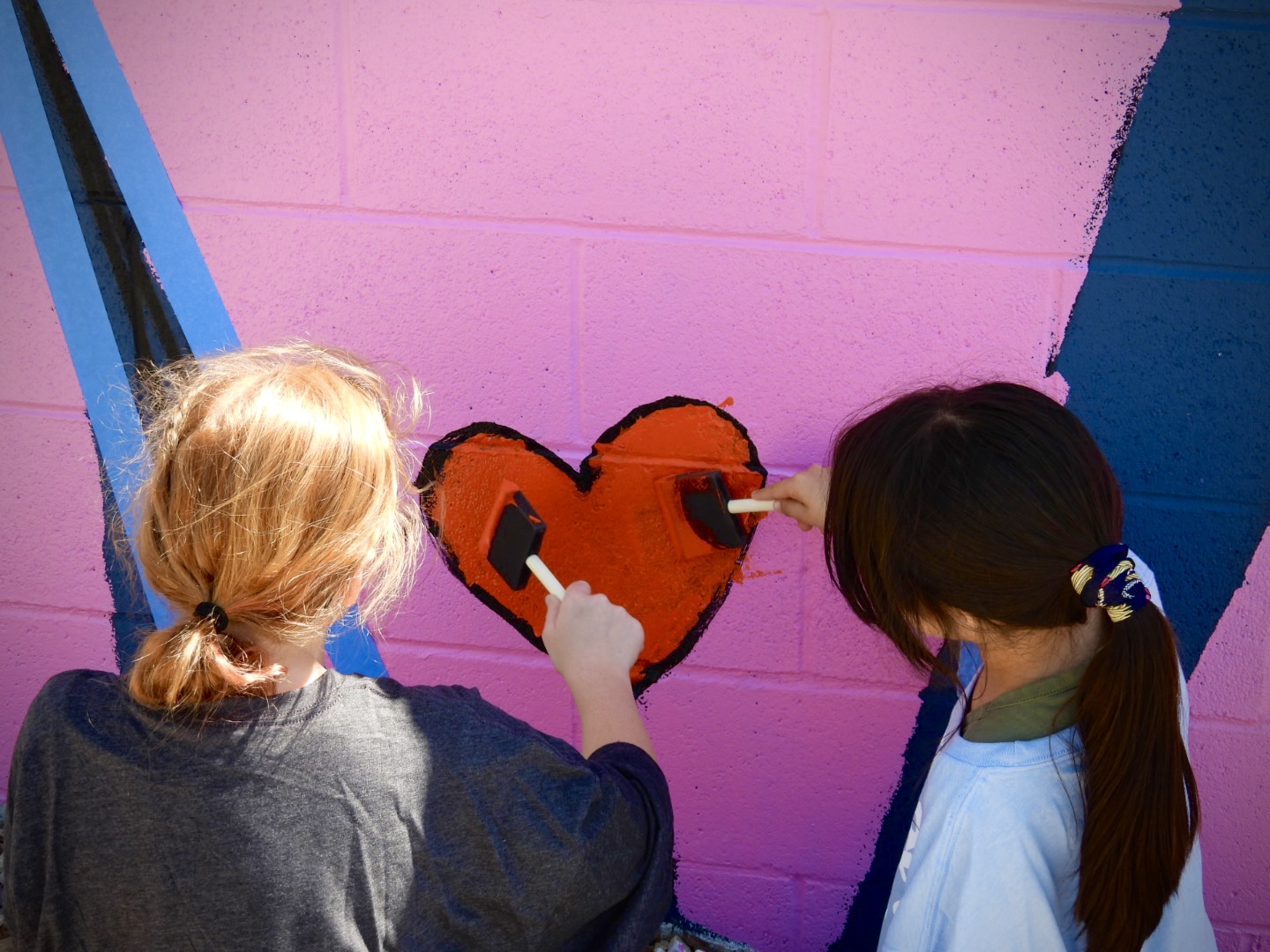 Youth paint a heart as part of a public art display during South Salt Lake's 2025 mural fest. The city was recently recognized in Good Housekeeping magazine for the city's kindness initiatives in partnership with One Kind Act a Day.
