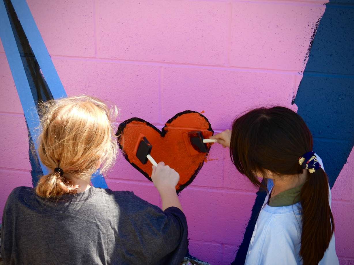Youth paint a heart as part of a public art display during South Salt Lake's 2025 mural fest. The city was recently recognized in Good Housekeeping magazine for the city's kindness initiatives in partnership with One Kind Act a Day.