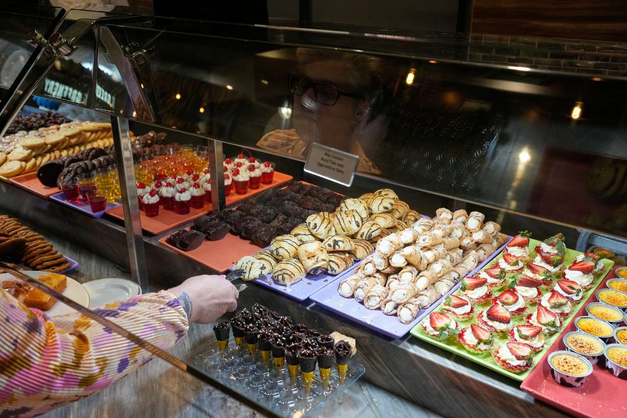 A person picks out dessert at the A.Y.C.E Buffet in the Palms resort-casino Wednesday in Las Vegas.