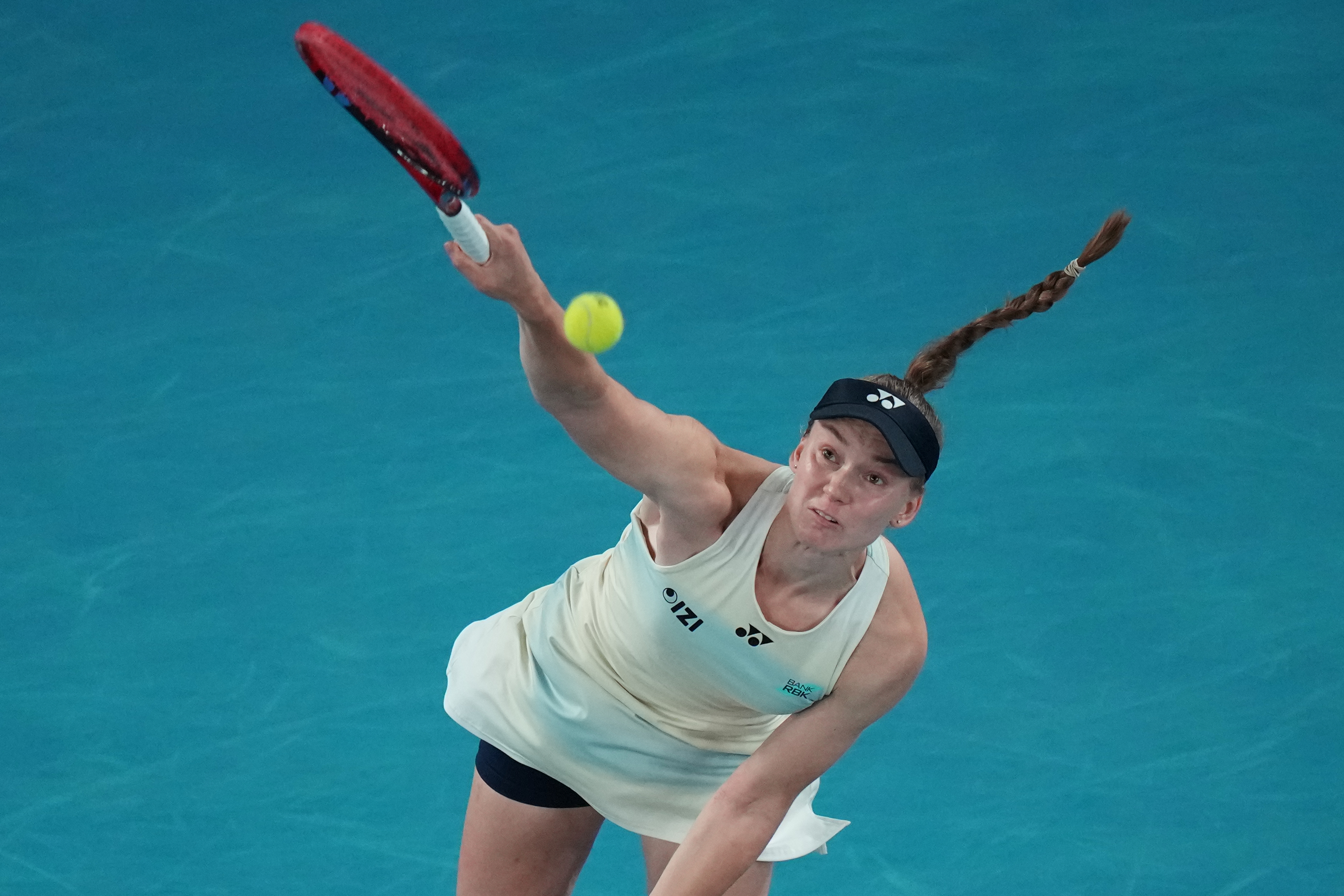 Elena Rybakina of Kazakhstan serves the ball to Aryna Sabalenka of Belarus during the women's singles final at the Australian Open tennis championship in Melbourne, Australia, Saturday, Jan. 31, 2026. 