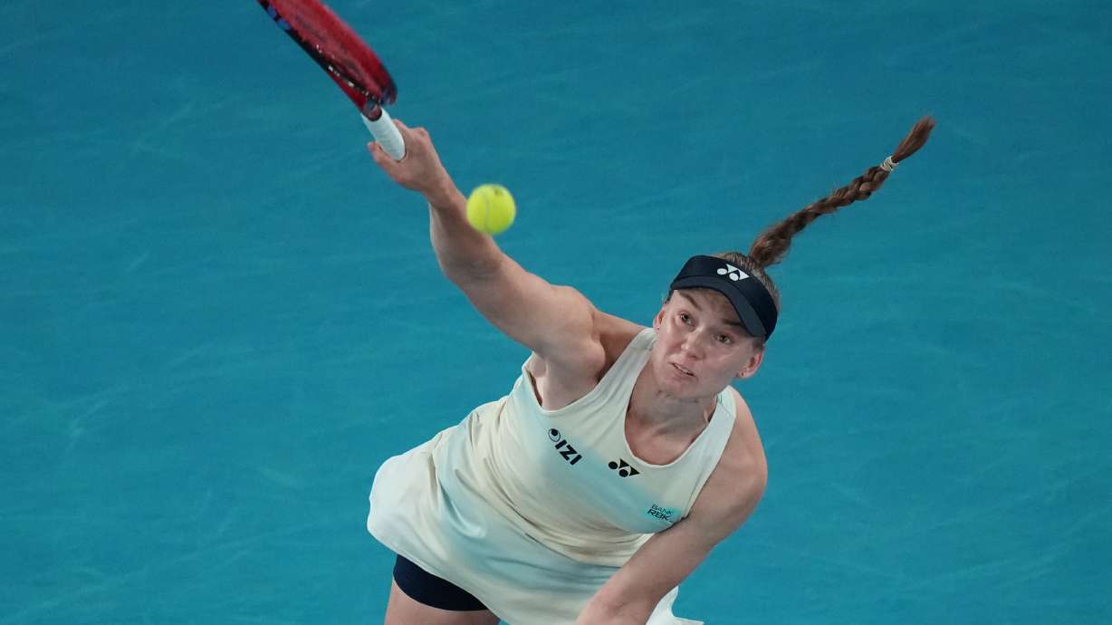 Elena Rybakina of Kazakhstan serves the ball to Aryna Sabalenka of Belarus during the women's singles final at the Australian Open tennis championship in Melbourne, Australia, Saturday, Jan. 31, 2026.