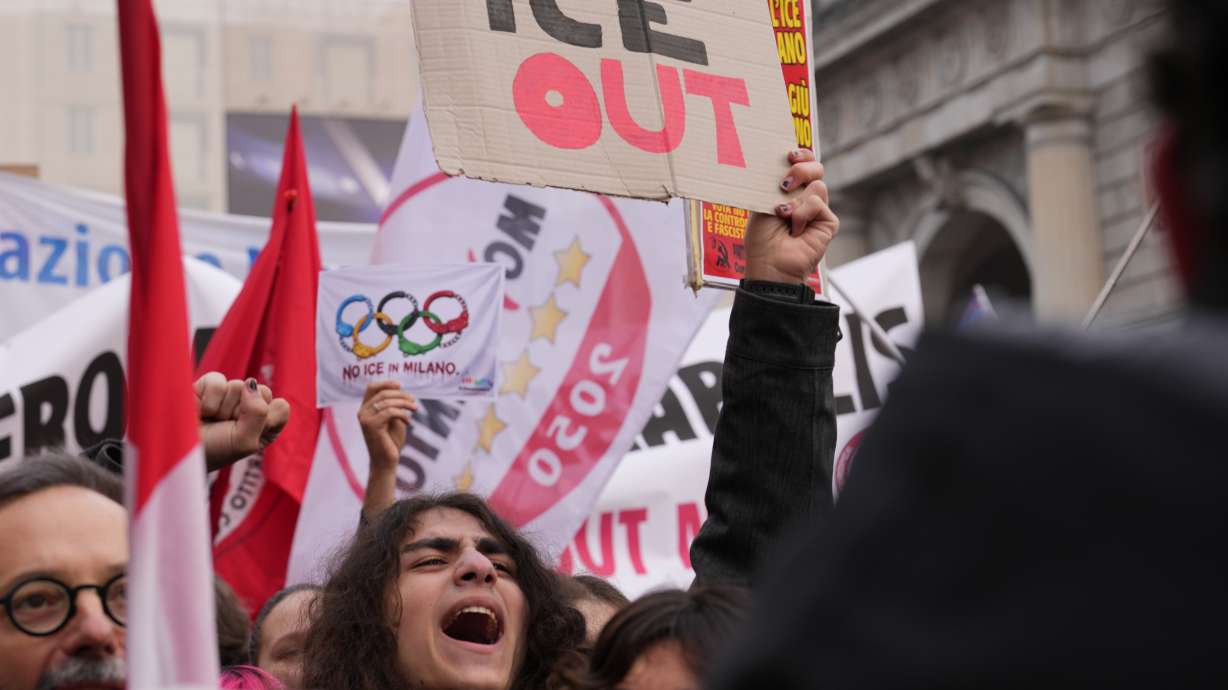 A person holds a sign, during an Anti-ICE demonstration, ahead of the 2026 Winter Olympics, in Milan, Italy, Saturday, Jan. 31, 2026.