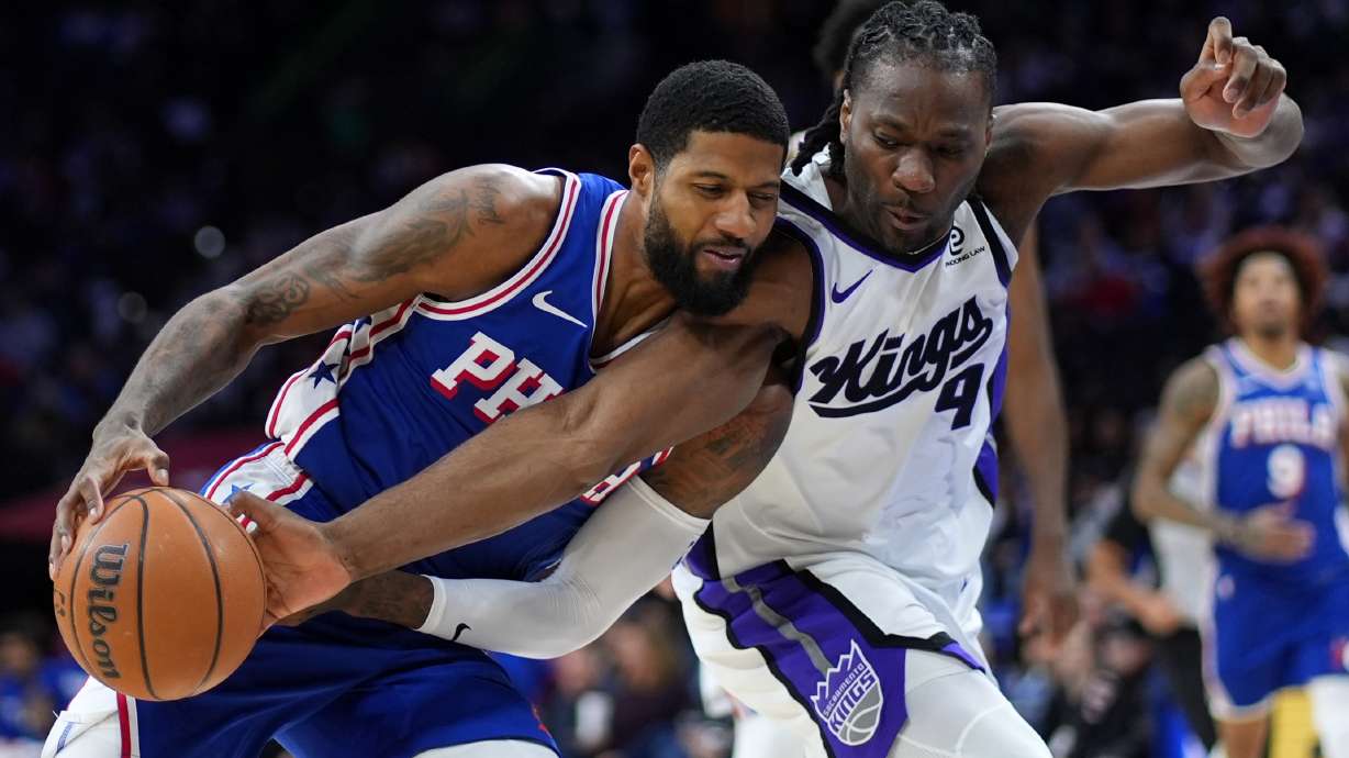 Philadelphia 76ers' Paul George, left, tries to get past Sacramento Kings' Precious Achiuwa during the second half of an NBA basketball game Thursday, Jan. 29, 2026, in Philadelphia.