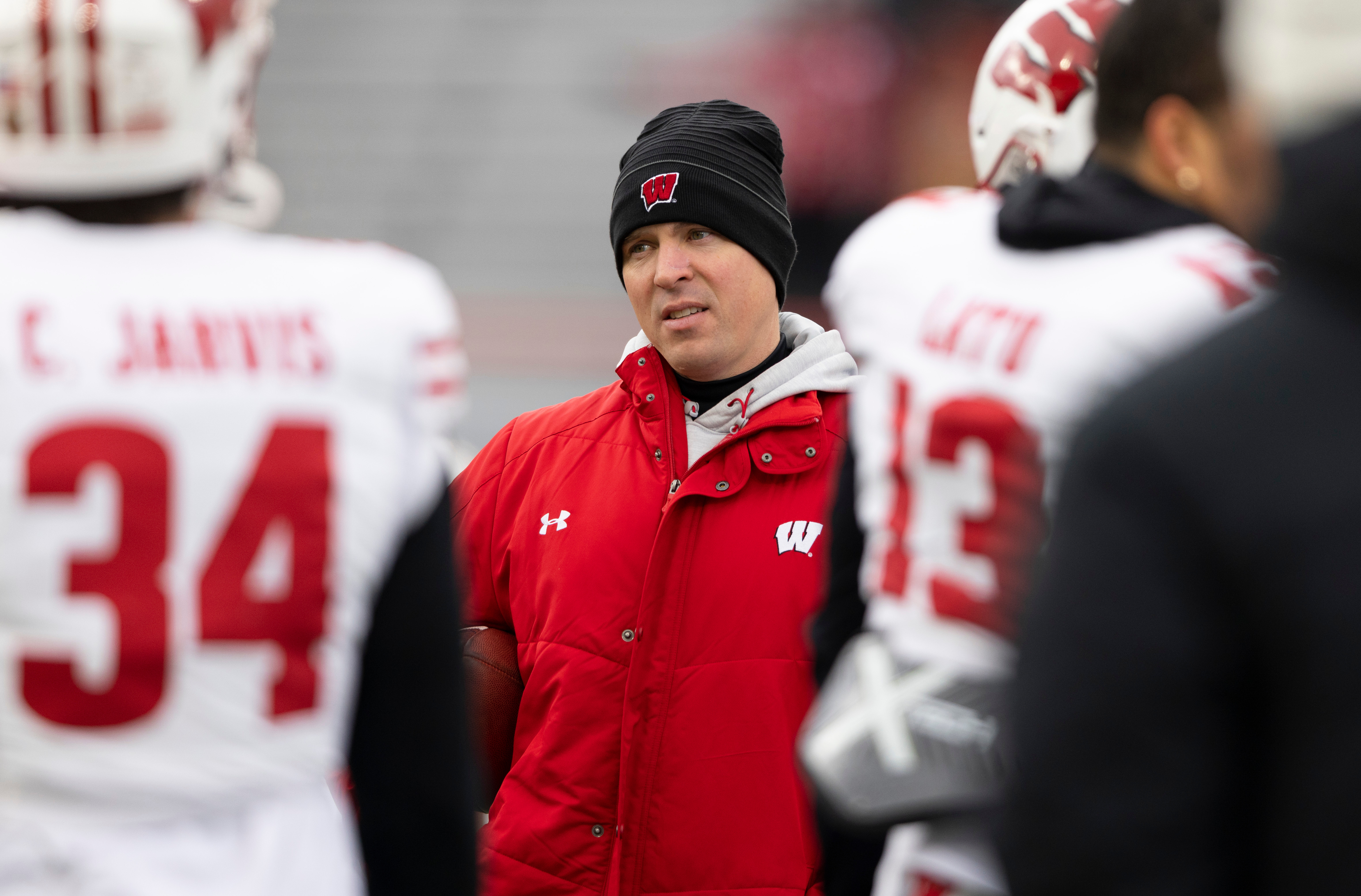 FILE - Wisconsin interim head coach Jim Leonhard leads warmups before playing against Nebraska in an NCAA college football game in Lincoln, Neb., Nov. 19, 2022. 