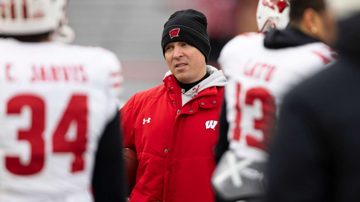 FILE - Wisconsin interim head coach Jim Leonhard leads warmups before playing against Nebraska in an NCAA college football game in Lincoln, Neb., Nov. 19, 2022.