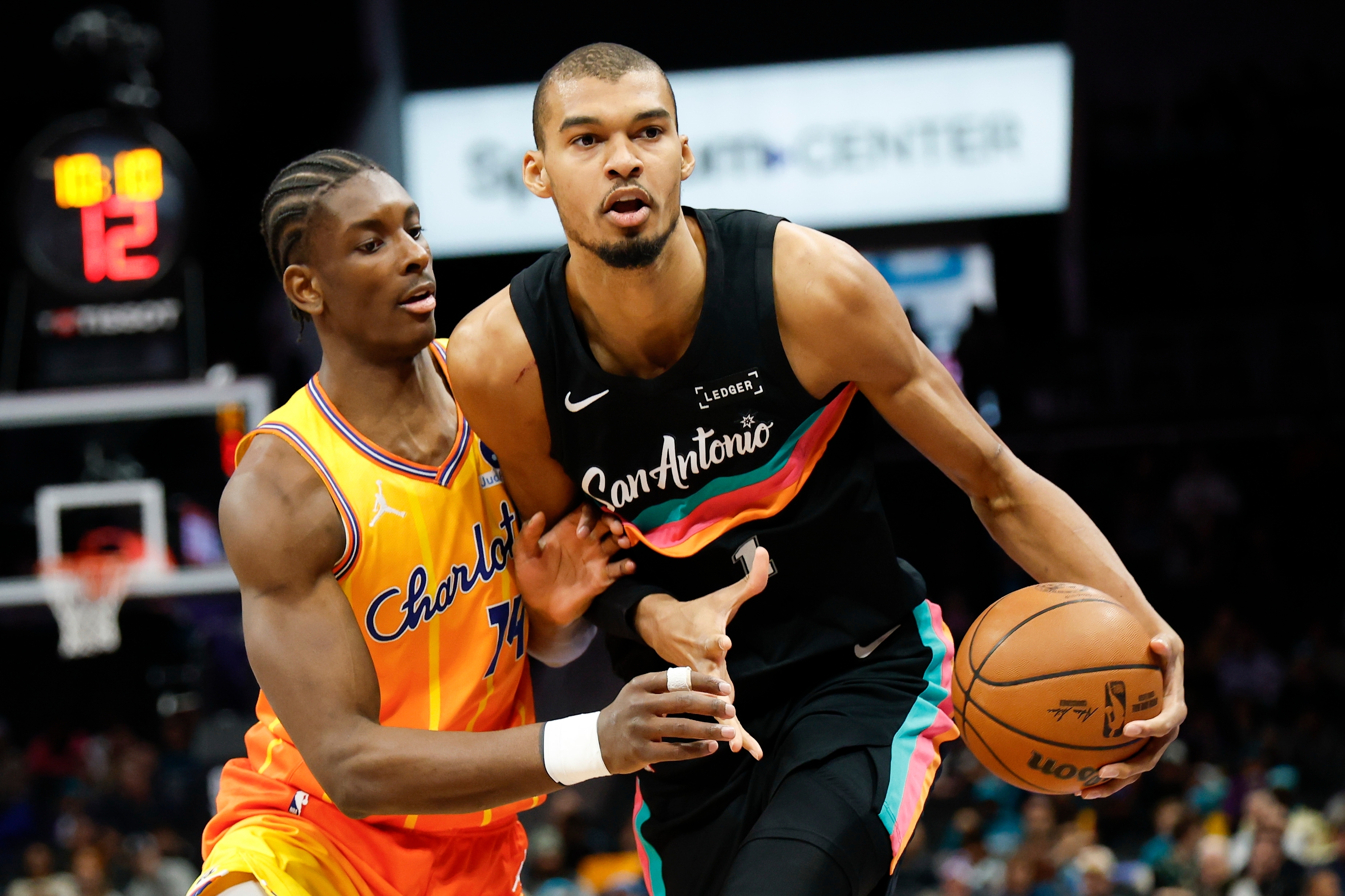 San Antonio Spurs forward Victor Wembanyama, right, moves the ball against Charlotte Hornets forward Moussa Diabate during the first half of an NBA basketball game in Charlotte, N.C., Saturday, Jan. 31, 2026. 