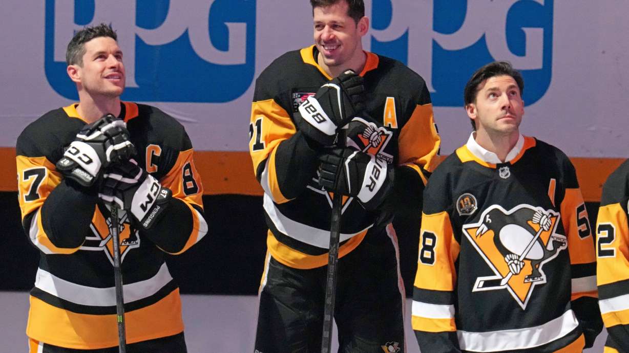 Members of the 2016 Stanley Cup Champion Pittsburgh Penguins, Sidney Crosby, left, Evgeni Malkin, center, and Kris Letang take part in a celebration of the 10th anniversary before an NHL hockey game against the New York Rangers in Pittsburgh, Saturday, Jan. 31, 2026.