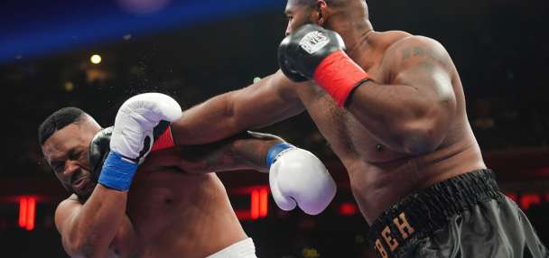 Boxer Jarrell Miller has his hairpiece knocked upward by a punch, then throws it into the crowd