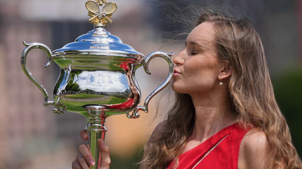 Elena Rybakina of Kazakhstan poses with Daphne Akhurst Memorial Cup on the banks of the Yarra River the morning after defeating Aryna Sabalenka of Belarus in the women's singles final at the Australian Open tennis championship in Melbourne, Australia, Sunday, Feb. 1, 2026.