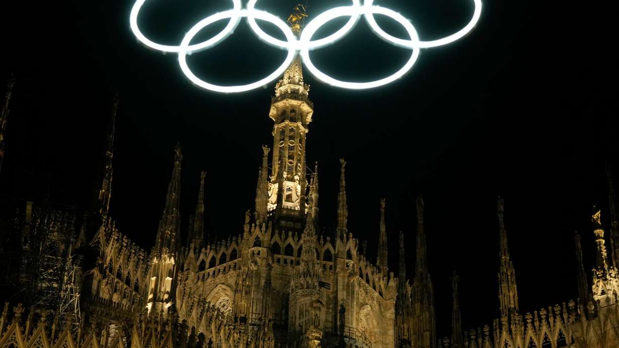 Neon Olympic rings hang next to the Duomo gothic cathedral for the upcoming Milan-Cortina Winter Olympics in Milan, Italy, Dec. 27, 2025.