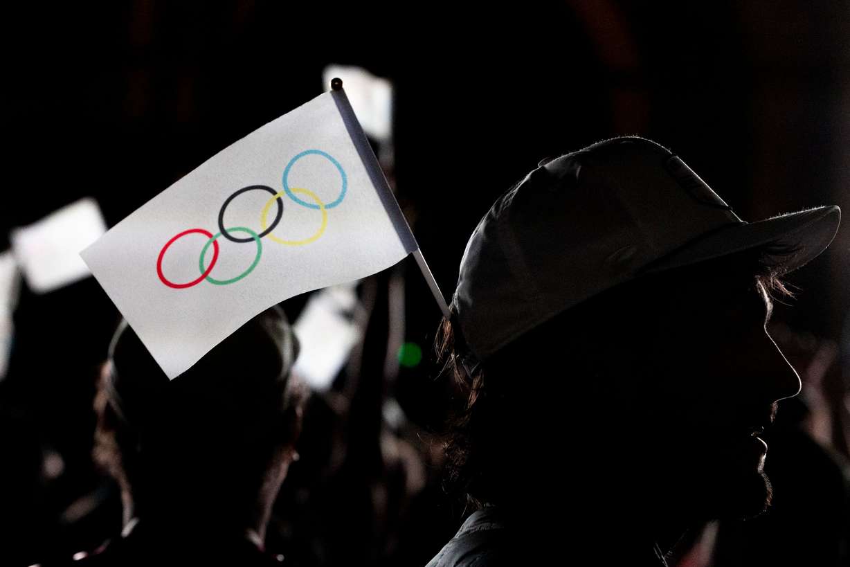 Jason D’Richards, of Salt Lake City, sports a flag in his hat during a live watch party for the Salt Lake City-Utah Committee’s 2034 Winter Olympics bid held at the Salt Lake City and County Building in Washington Square Park on July 24, 2024, in downtown Salt Lake City.