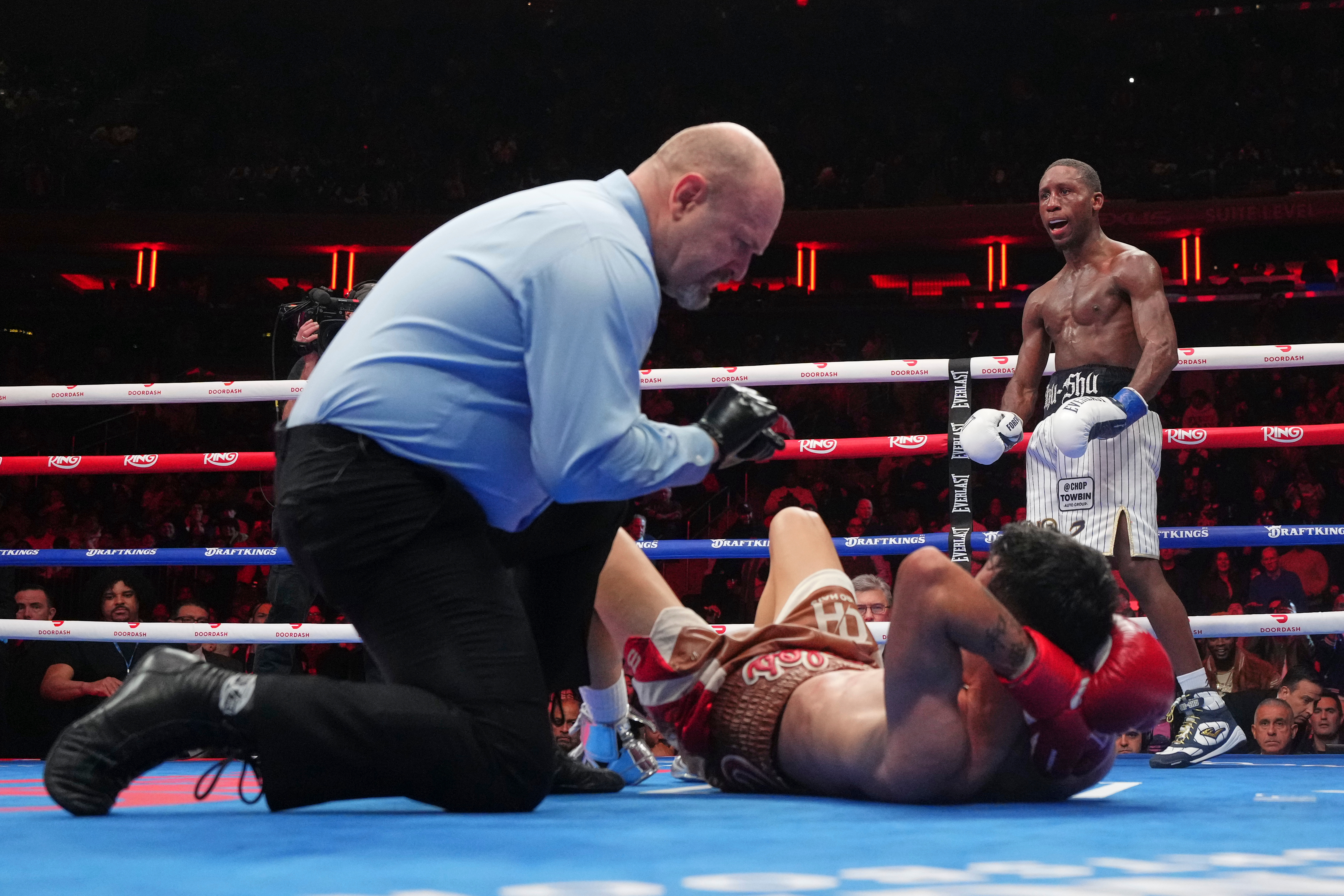 Bruce Carrington celebrates as the referee counts for Carlos Castro during a featherweight title boxing match Saturday, Jan. 31, 2026, in New York. 