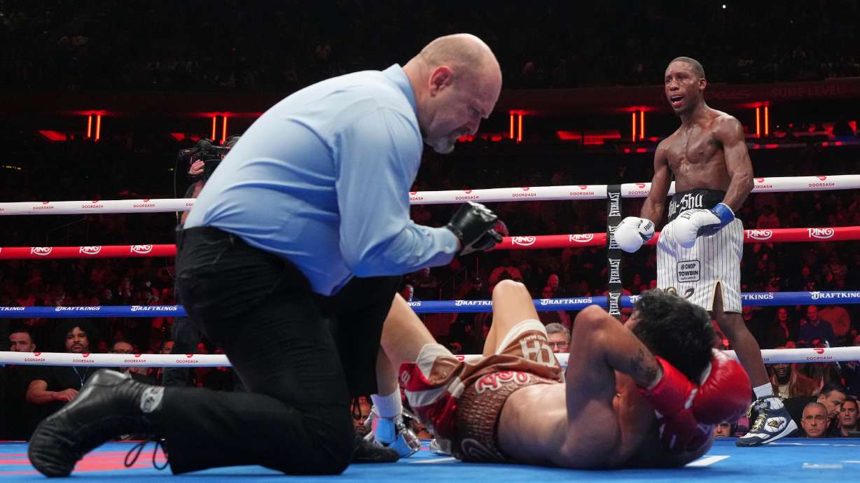 Bruce Carrington celebrates as the referee counts for Carlos Castro during a featherweight title boxing match Saturday, Jan. 31, 2026, in New York.