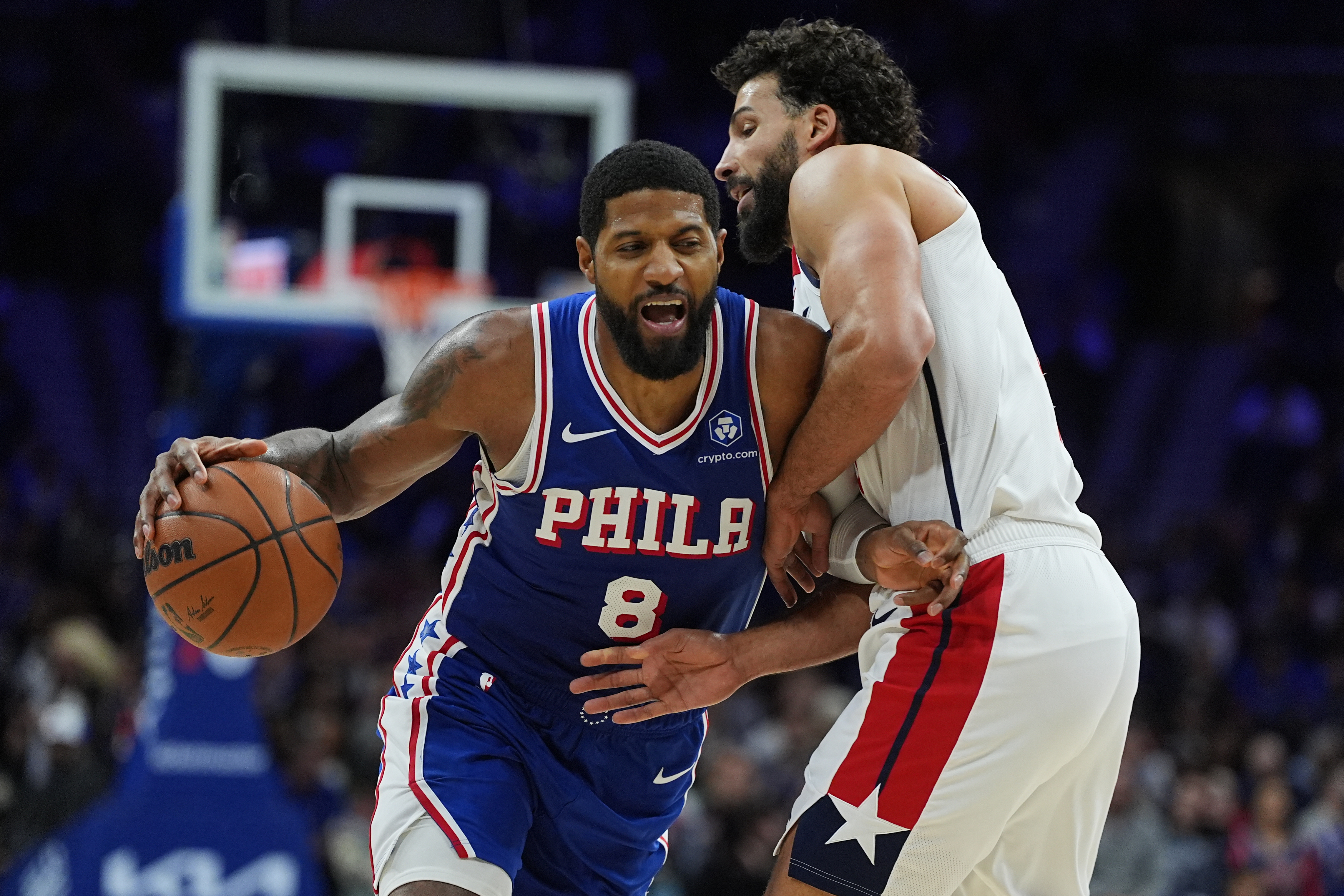 Philadelphia 76ers' Paul George (8) tries to get a shot past Washington Wizards' Anthony Gill during the second half of an NBA basketball game Wednesday, Jan. 7, 2026, in Philadelphia. 