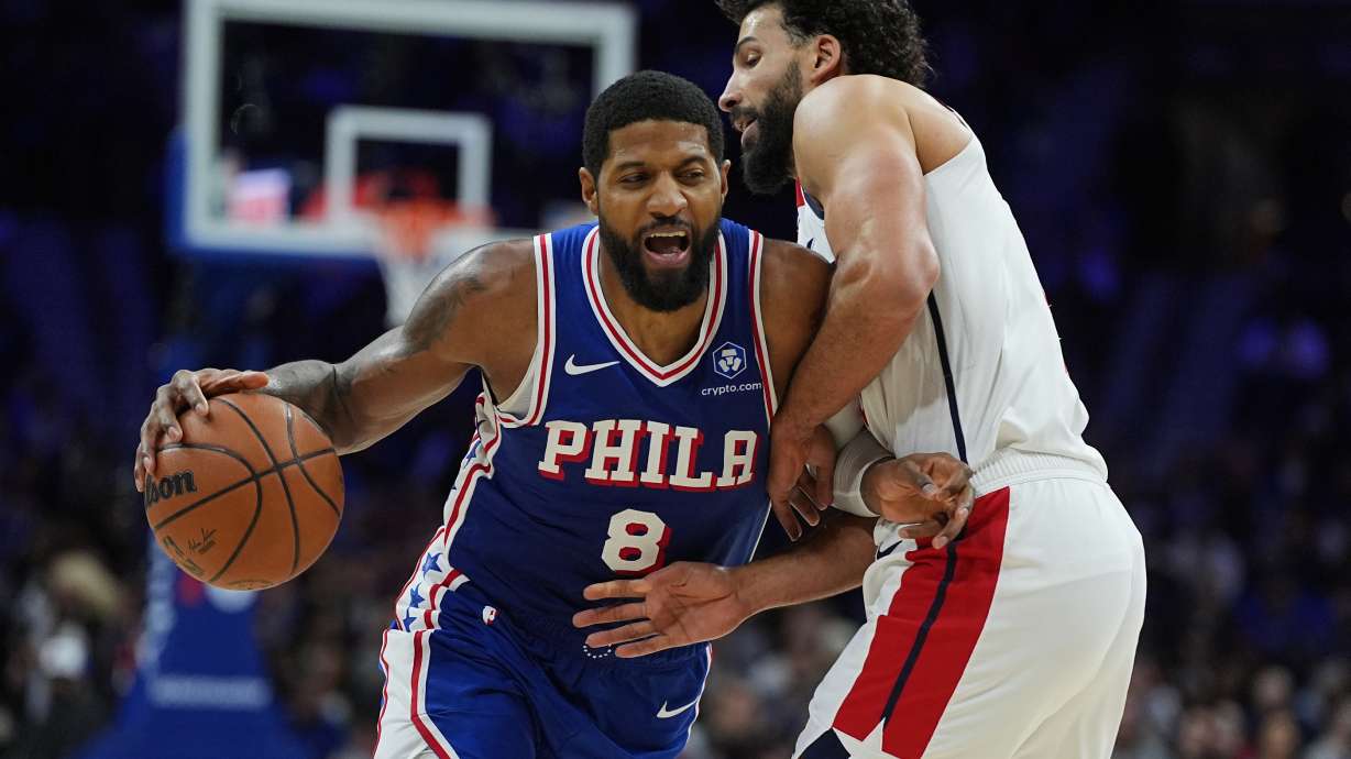 Philadelphia 76ers' Paul George (8) tries to get a shot past Washington Wizards' Anthony Gill during the second half of an NBA basketball game Wednesday, Jan. 7, 2026, in Philadelphia.