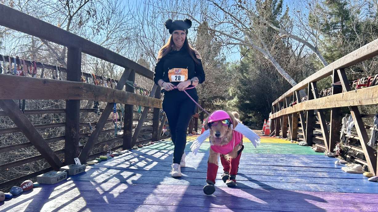 Rocky Shalby crosses Rainbow Bridge with her dog, Zara, as part of the third annual I Heart Pets 10K/5K/Fun Run Walk N' Roll on Jan. 31 in St. George.