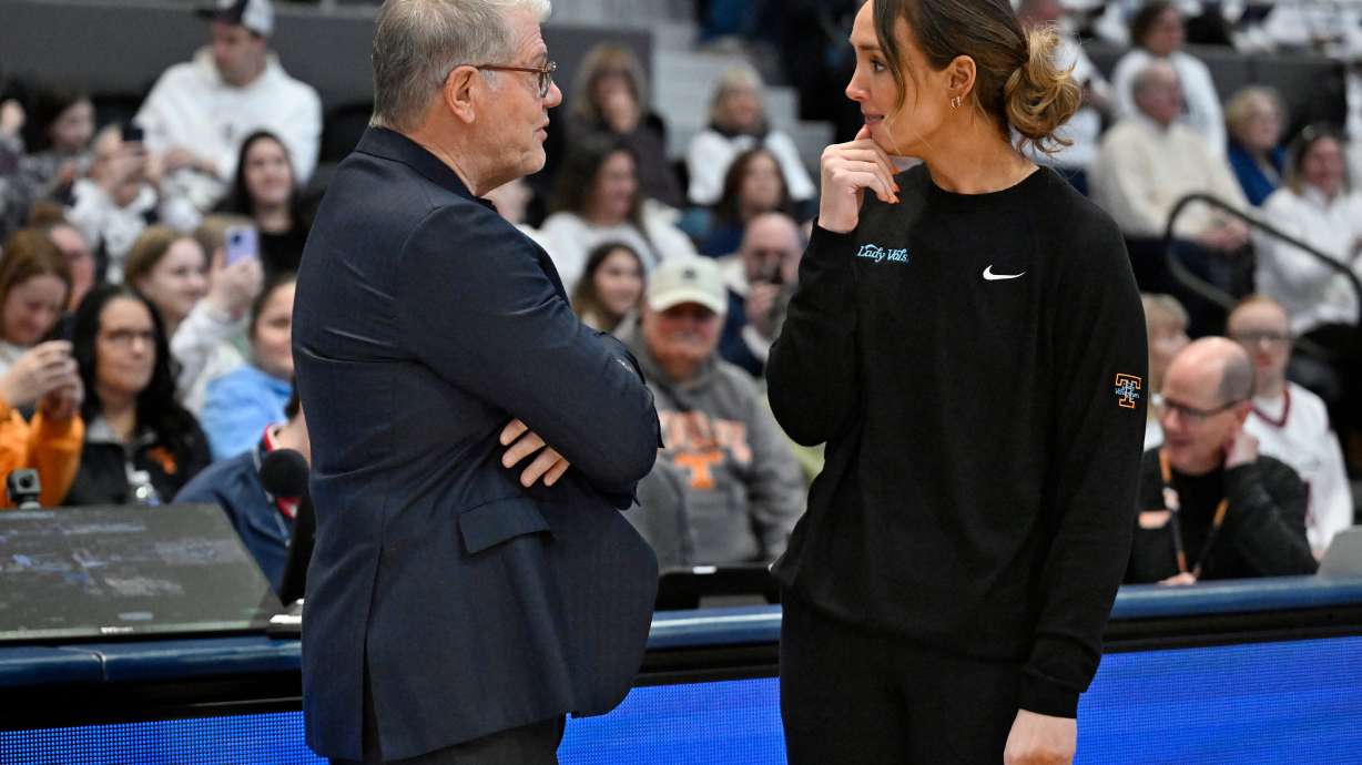 UConn head coach Geno Auriemma, left, talks with Tennessee head coach Kim Caldwell, right, before an NCAA college basketball game, Sunday, Feb. 1, 2026, in Hartford, Conn.
