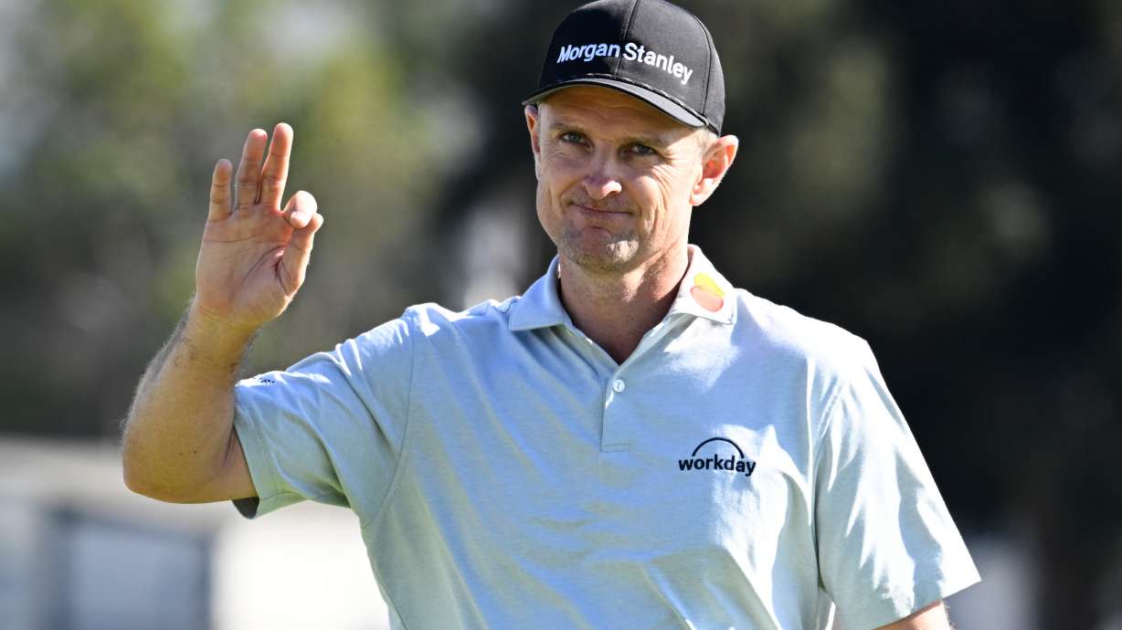 Justin Rose, of England, waves to the gallery on the 15th green of the South Course at Torrey Pines during the final round of the Farmers Insurance Open golf tournament Sunday, Feb. 1, 2026, in San Diego.