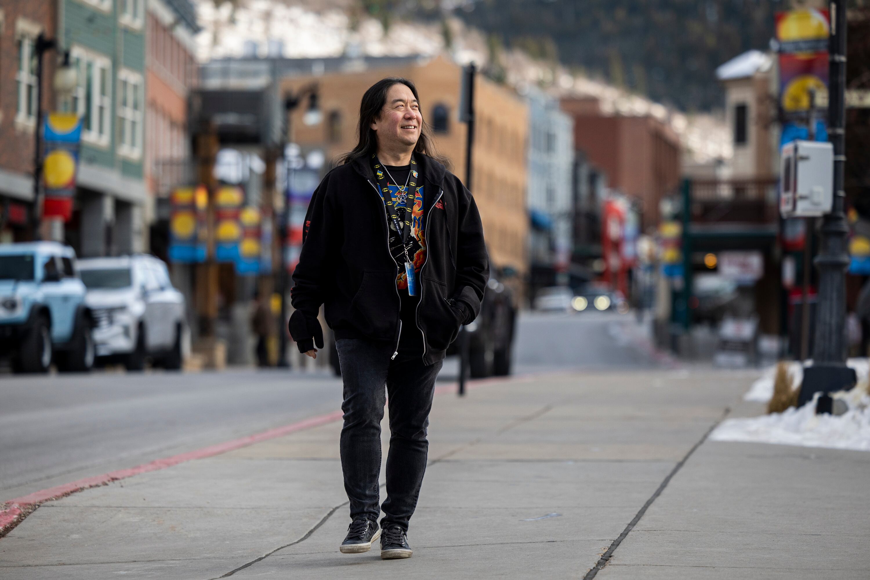 Scott Iwasaki, scene editor at The Park Record who has covered the Sundance Film Festival for 30 years, walks along Main Street in Park City on Jan. 20.