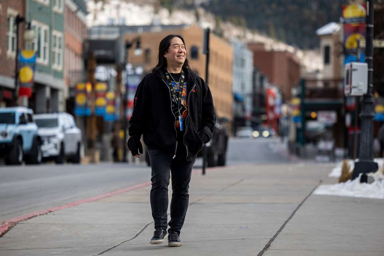 Scott Iwasaki, scene editor at The Park Record who has covered the Sundance Film Festival for 30 years, walks along Main Street in Park City on Jan. 20.