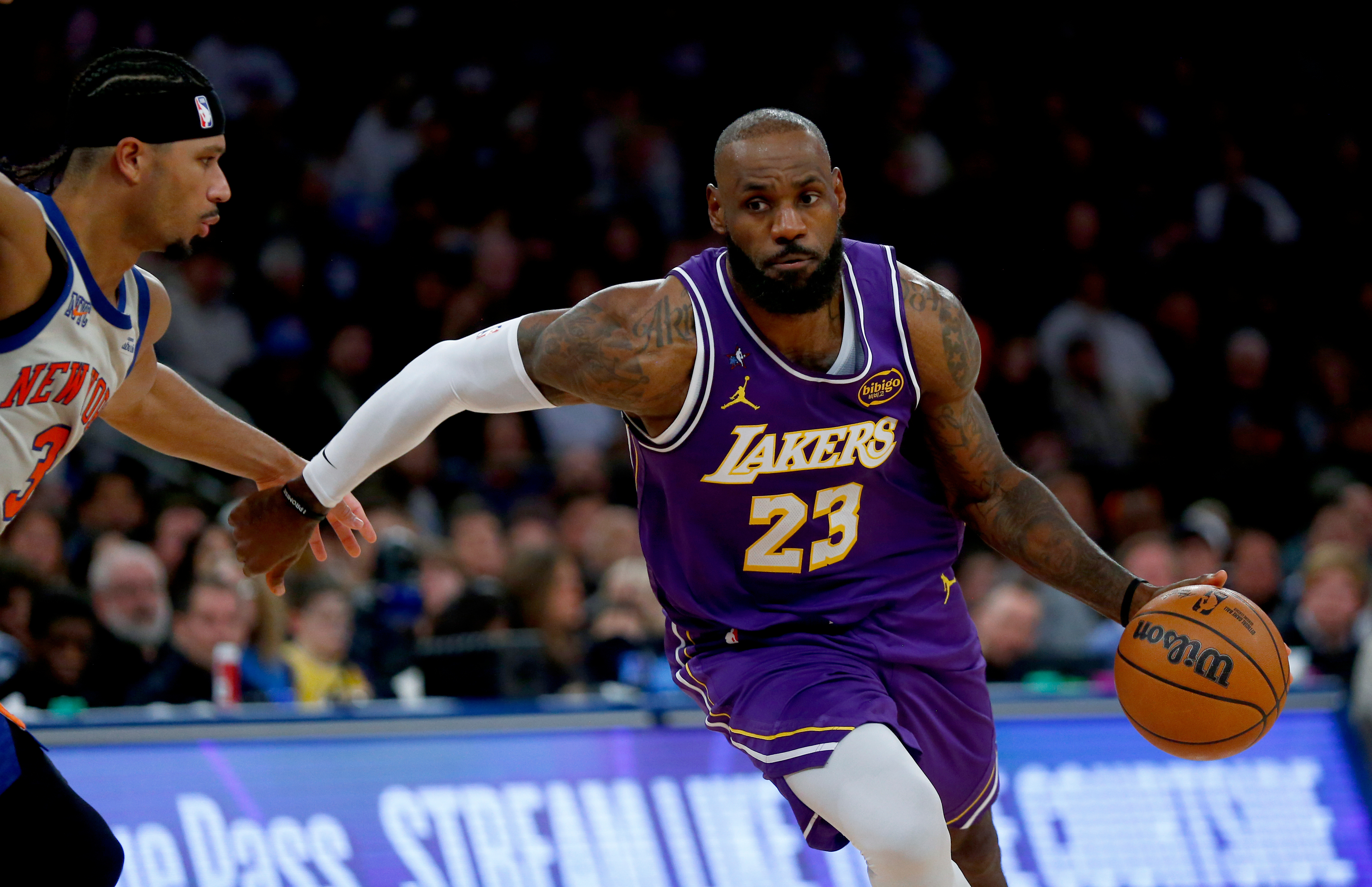 New York Knicks guard Josh Hart, left, defends against Los Angeles Lakers forward LeBron James, right, during the second half of an NBA basketball game, Sunday, Feb. 1, 2026, in New York. 