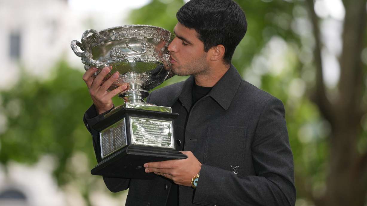 Carlos Alcaraz of Spain kisses the Norman Brookes Challenge Cup the morning after defeating Novak Djokovic of Serbia in the men's singles final at the Australian Open tennis championship, in Melbourne, Australia, Monday, Feb. 2, 2026.