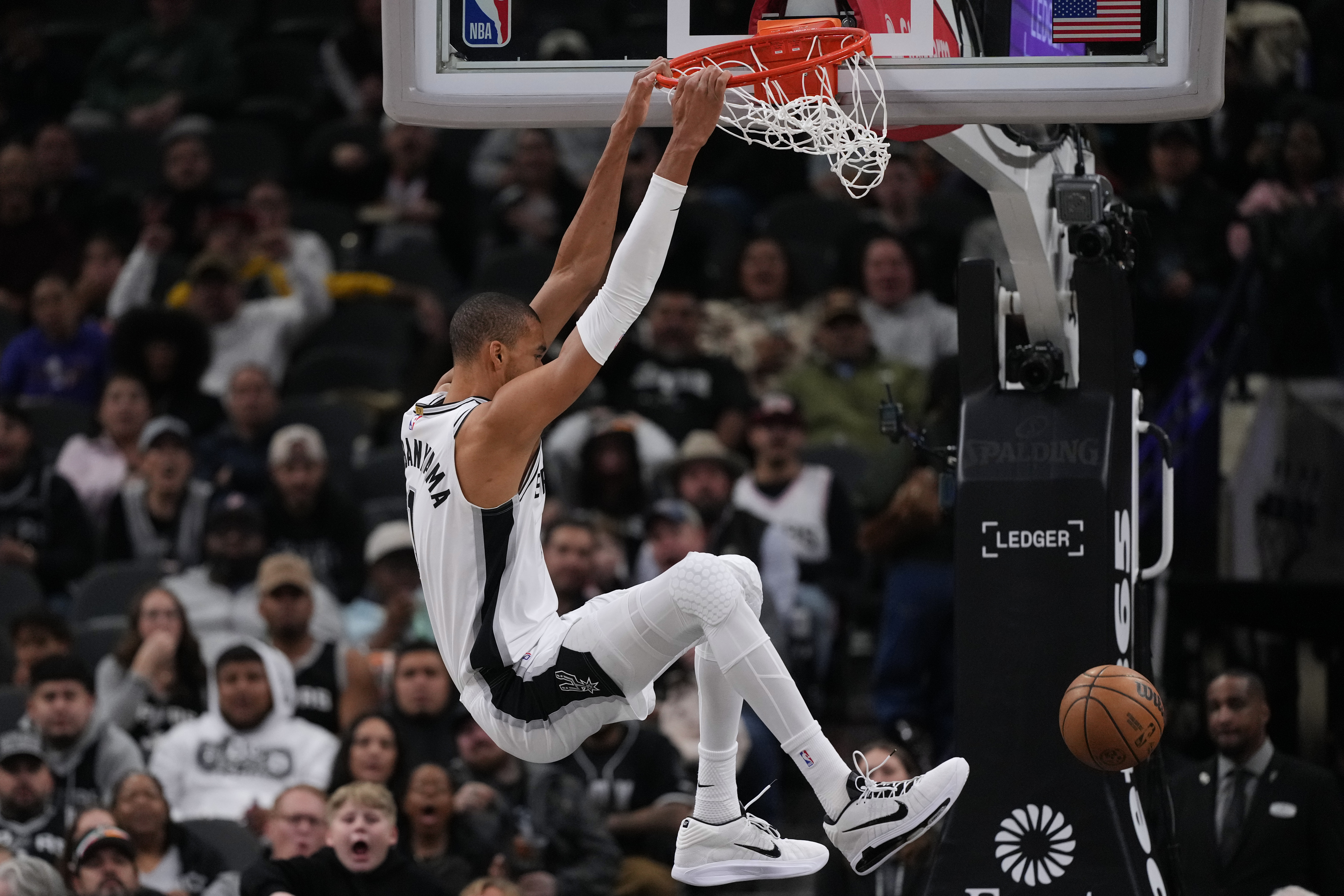 San Antonio Spurs forward Victor Wembanyama (1) scores against the Orlando Magic during the first half of an NBA basketball game in San Antonio, Sunday, Feb. 1, 2026. 