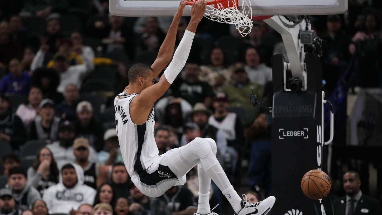 San Antonio Spurs forward Victor Wembanyama (1) scores against the Orlando Magic during the first half of an NBA basketball game in San Antonio, Sunday, Feb. 1, 2026.