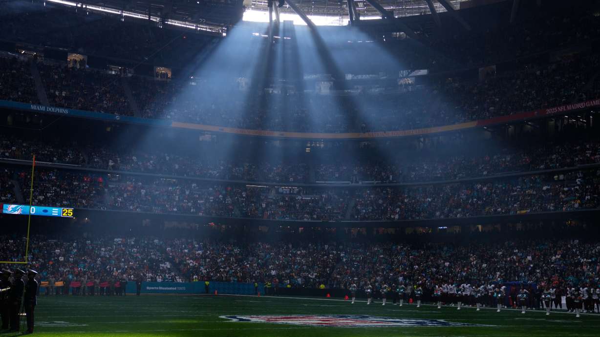FILE - A shaft of sunlight streams into the stadium before an NFL football game between the Washington Commanders and the Miami Dolphins in Madrid, Spain, Sunday, Nov. 16, 2025.