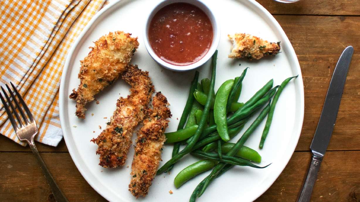 This image shows a recipe for crispy chicken strips with an apricot mustard dipping sauce.