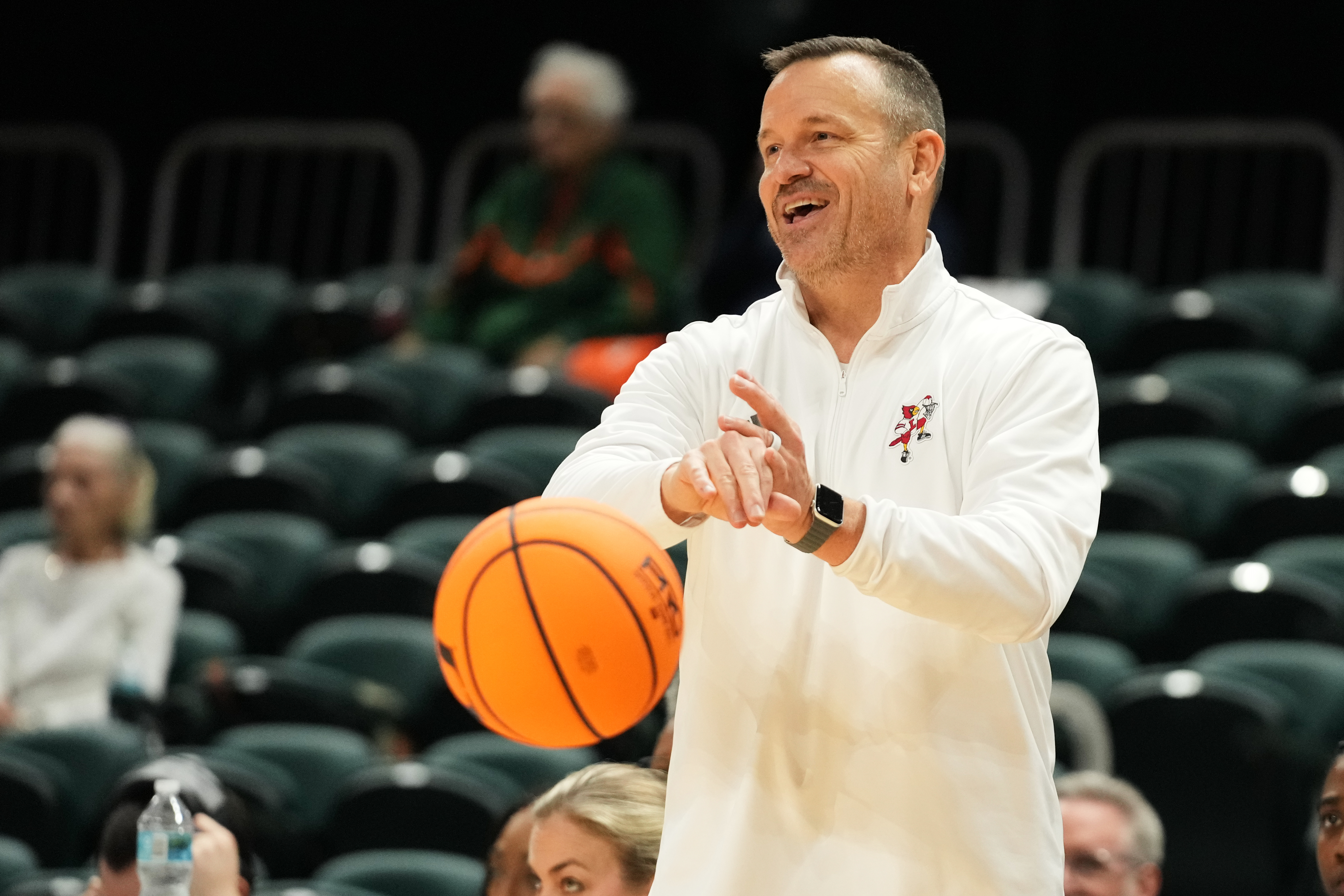 Louisville head coach Jeff Walz puts the ball back into play during the second half of an NCAA college basketball game against Miami, Thursday, Jan. 8, 2026, in Coral Gables, Fla. 