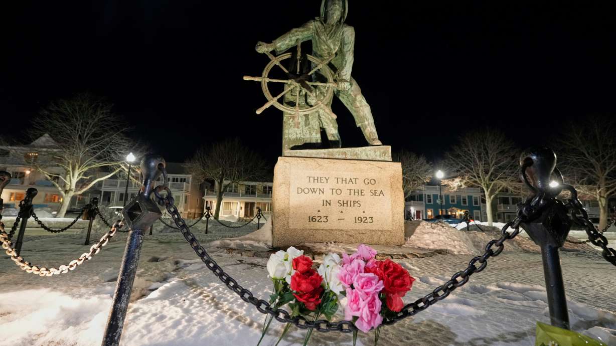 Flowers are placed at the Gloucester Fisherman's Memorial in Gloucester, Mass., after a fishing boat from a port city went missing off the coast of Massachusetts with multiple people on board, Jan. 30.