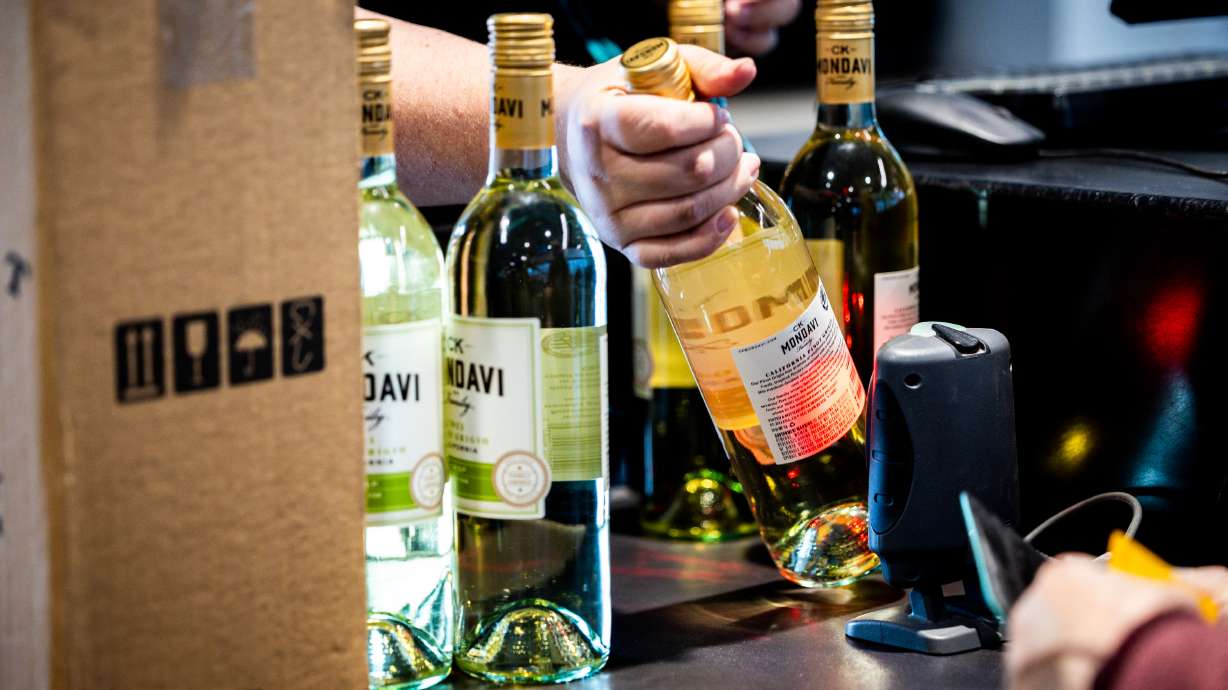 A Utah Department of Alcoholic Beverage Services employee bags wine for a customer at a state liquor store in Salt Lake City on March 31, 2025. A new state liquor store in Moab opened its doors to customers for the first time Monday.