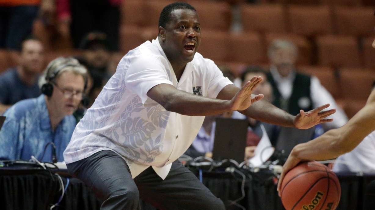FILE - Hawaii coach Benjy Taylor gestures to his team during the first half of an NCAA college basketball game against UC Davis in the semifinals of the Big West Conference tournament, March 13, 2015, in Anaheim, Calif.