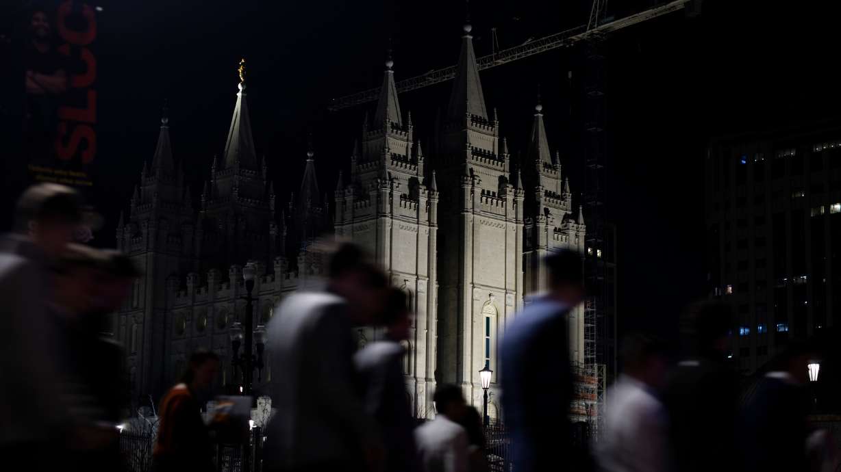 The Salt Lake Temple is illuminated as attendees exit from a Worldwide Devotional for Young Adults on Sunday. Salt Lake City is considering a few long-standing road closures for when the six-month temple open house is held in 2027.