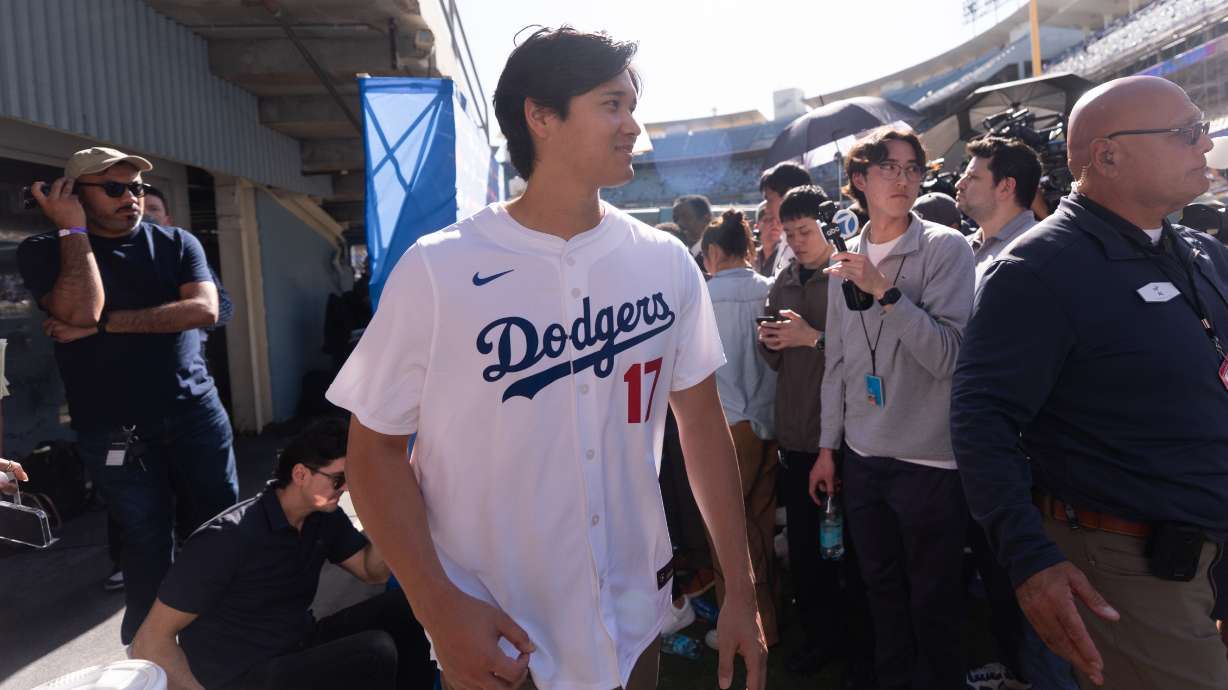 Los Angeles Dodgers two-way player Shohei Ohtani leaves after talking to reporters during DodgerFest at Dodger Stadium in Los Angeles, Saturday, Jan. 31, 2026.