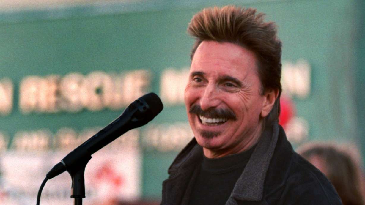 Chuck Negron, former lead singer of Three Dog Night, sings to a crowd during a Christmas Eve party, Dec. 24, 1997, at the Union Rescue Mission in Los Angeles. He died Monday. He was 83.