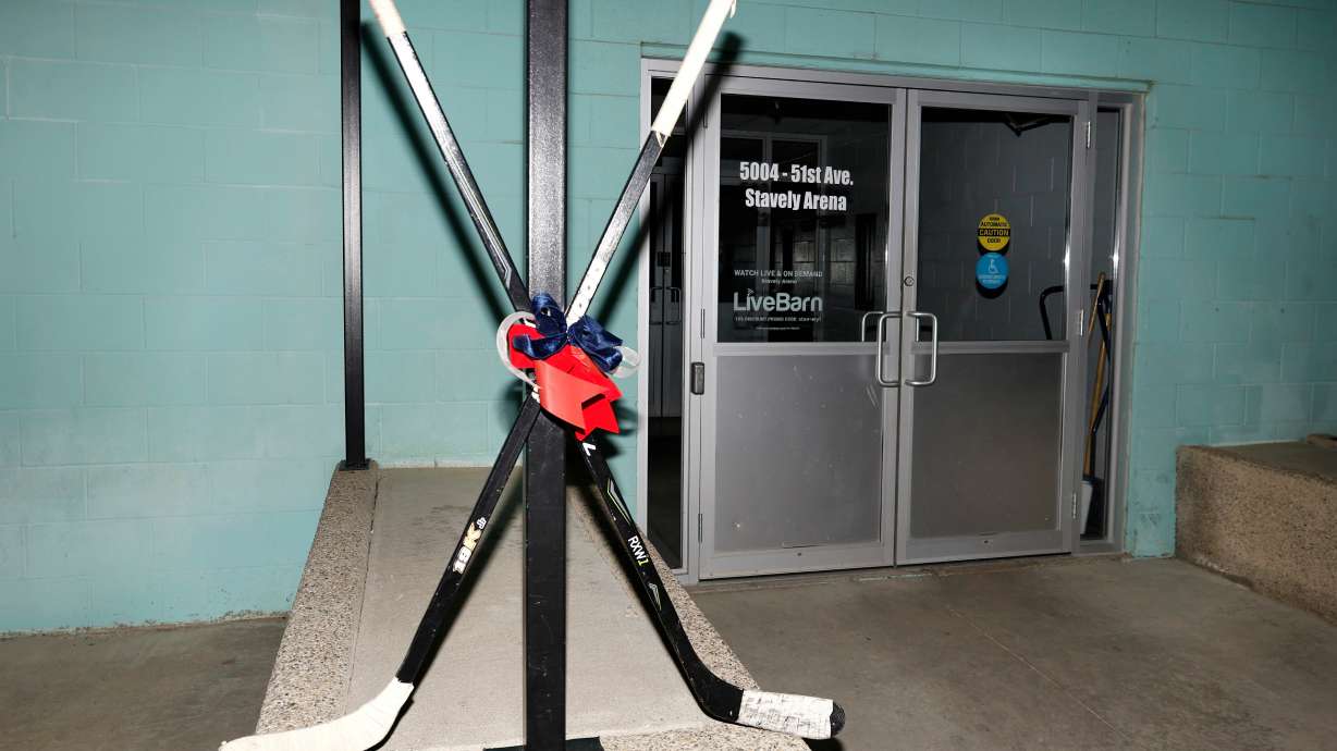Crossed hockey sticks are shown outside of the Stavely Arena in Stavely, Alberta, Monday, Feb. 2, 2026.