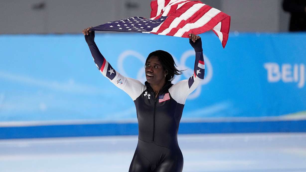 FILE - Erin Jackson of the United States hoists an American flag after winning the gold medal in the speedskating women's 500-meter race at the 2022 Winter Olympics, Sunday, Feb. 13, 2022, in Beijing.