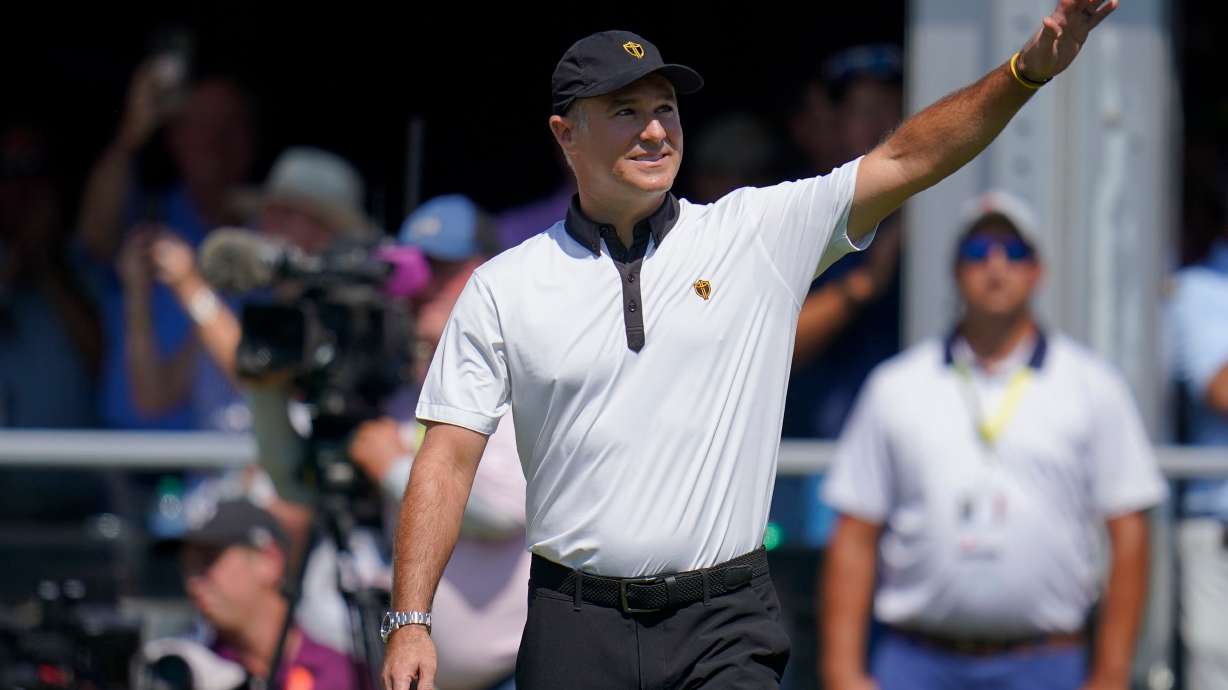 FILE - International team captain Trevor Immelman waves toward the gallery before a foursomes match at the Presidents Cup golf tournament at the Quail Hollow Club, Sept. 22, 2022, in Charlotte, N.C.