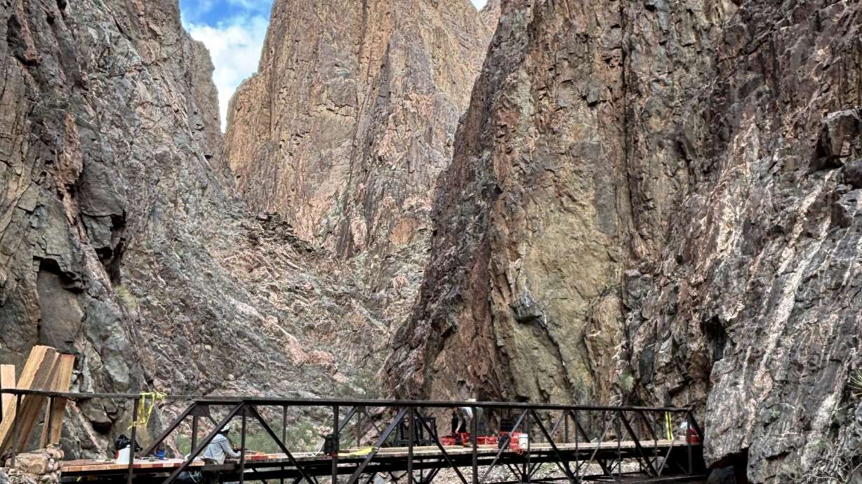 A trail crew redecks a footbridge along the North Kaibab Trail at Grand Canyon National Park in January. Park officials said Tuesday that a section of the trail will reopen on March 4, following a fire that closed the area on July 13, 2025.
