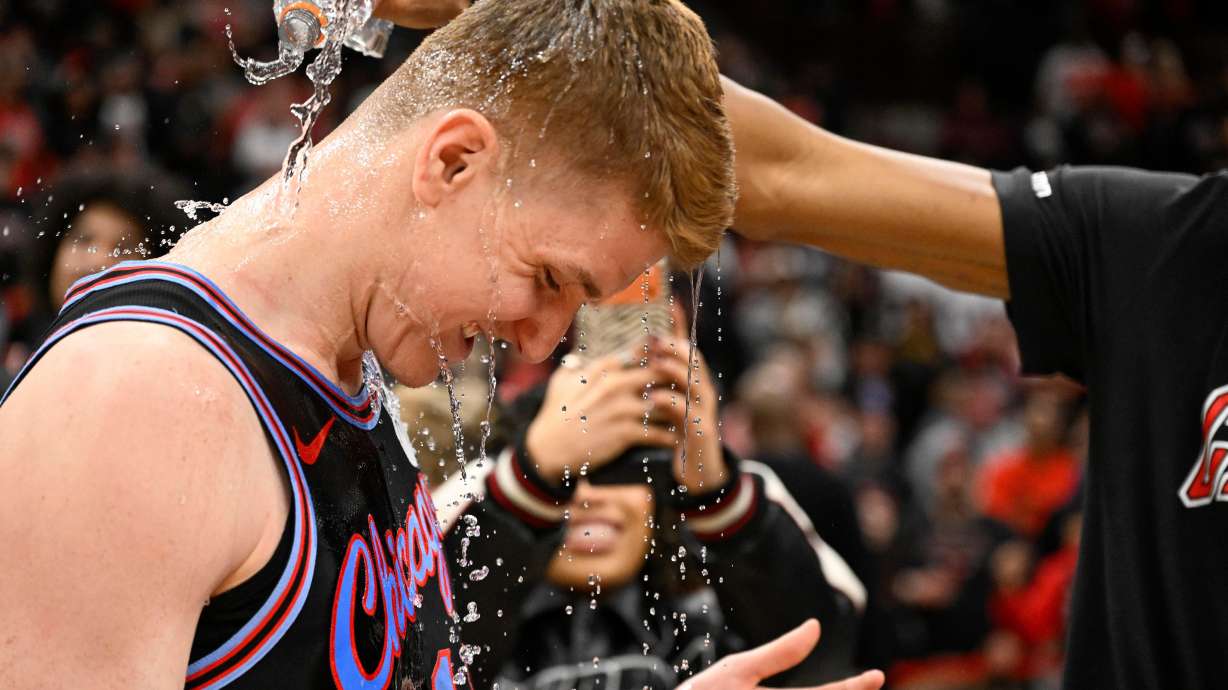 Chicago Bulls guard Kevin Huerter gets doused with water after an NBA basketball game against the Boston Celtics, Saturday, Jan. 24, 2026, in Chicago. Huerter scored the game winning three-point basket.