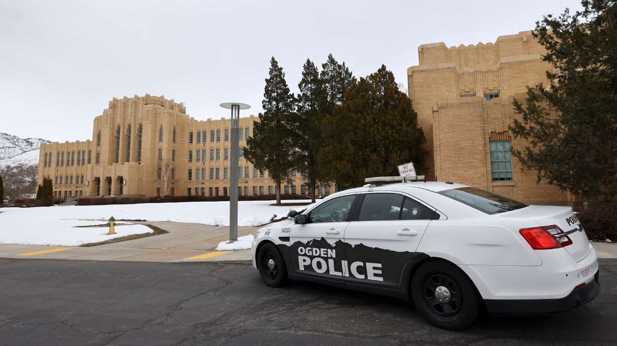 Police maintain a presence after responding to false threats of shots fired at Ogden High School in Ogden on March 29, 2023. Utah public schools are required to have a wearable panic alert system in place by the end of June 2026.
