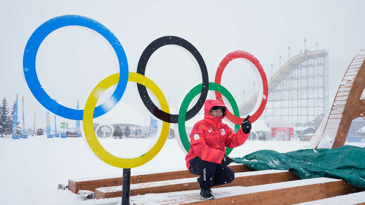 Japan's Goshin Fujiki poses for a photo in front of the Olympic rings at the 2026 Winter Olympics, in Livigno, Italy, Wednesday, Feb. 4, 2026.