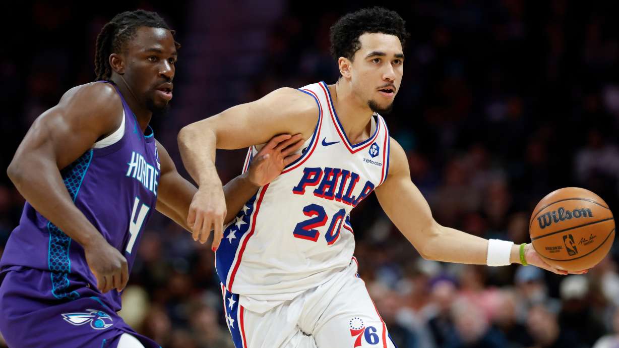 Philadelphia 76ers guard Jared McCain (20) moves the ball as Charlotte Hornets guard Sion James defends during the second half of an NBA basketball game in Charlotte, N.C., Monday, Jan. 26, 2026.