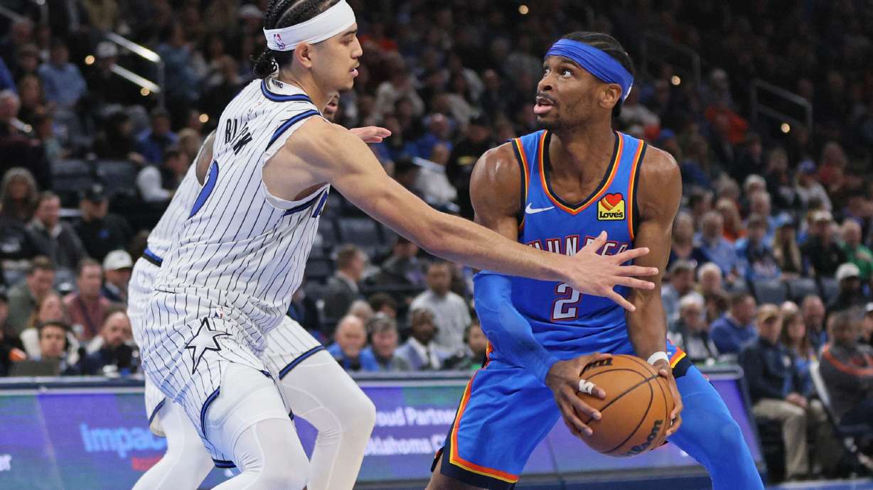 Oklahoma City Thunder guard Shai Gilgeous-Alexander (2) looks for an outlet against Orlando Magic guard Anthony Black, left, during the second half of an NBA basketball game, Tuesday, Feb. 3, 2026, in Oklahoma City.