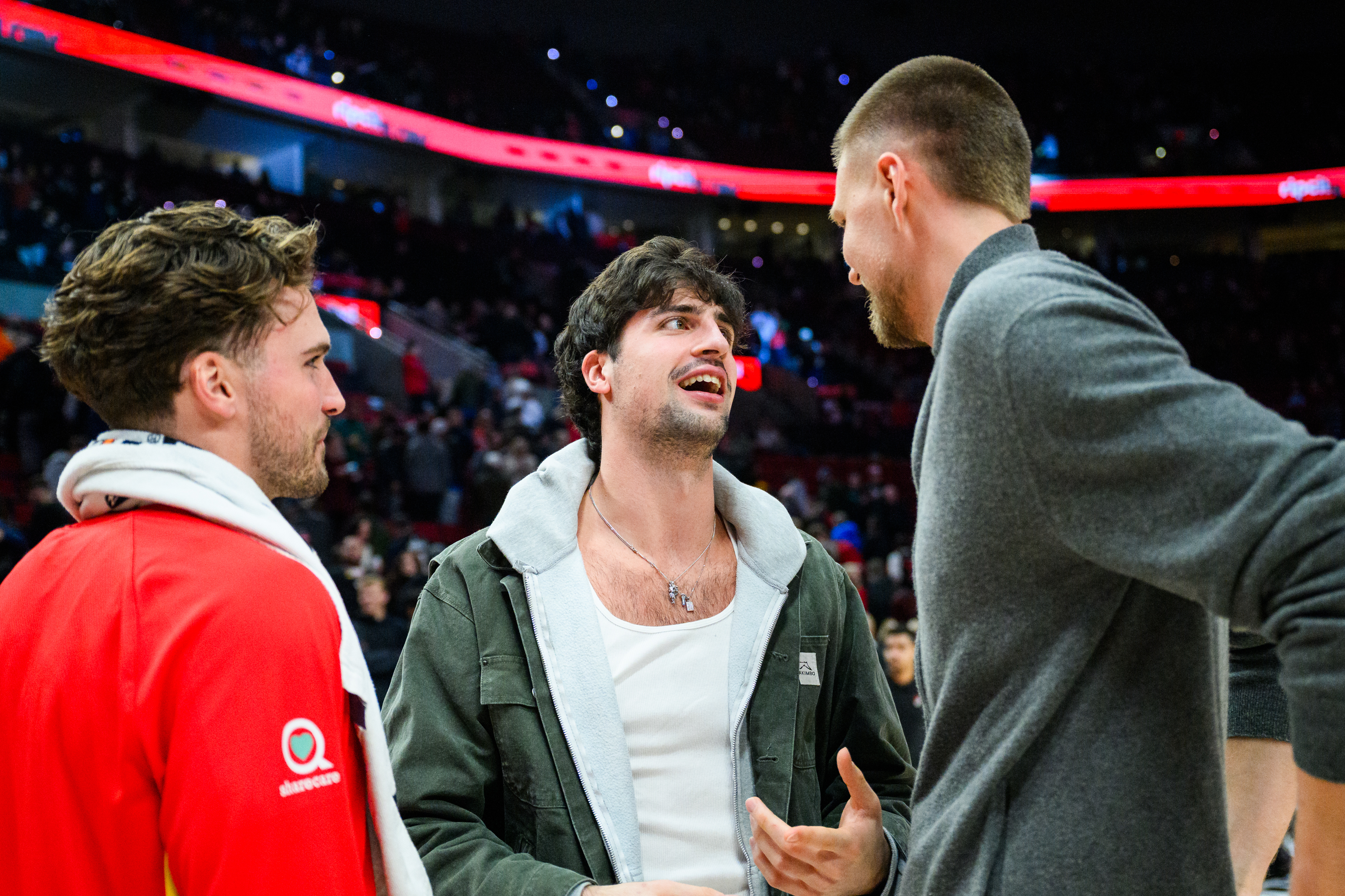 Portland Trail Blazers forward Deni Avdija, center, talks to Atlanta Hawks forwards Corey Kispert, left, and Kristaps Porzingis, right, after an NBA basketball game on Thursday, Jan. 15, 2026, in Portland, Ore. 