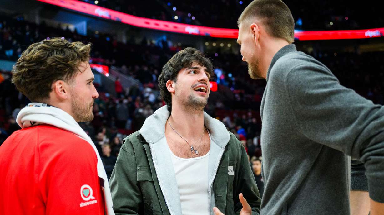 Portland Trail Blazers forward Deni Avdija, center, talks to Atlanta Hawks forwards Corey Kispert, left, and Kristaps Porzingis, right, after an NBA basketball game on Thursday, Jan. 15, 2026, in Portland, Ore.